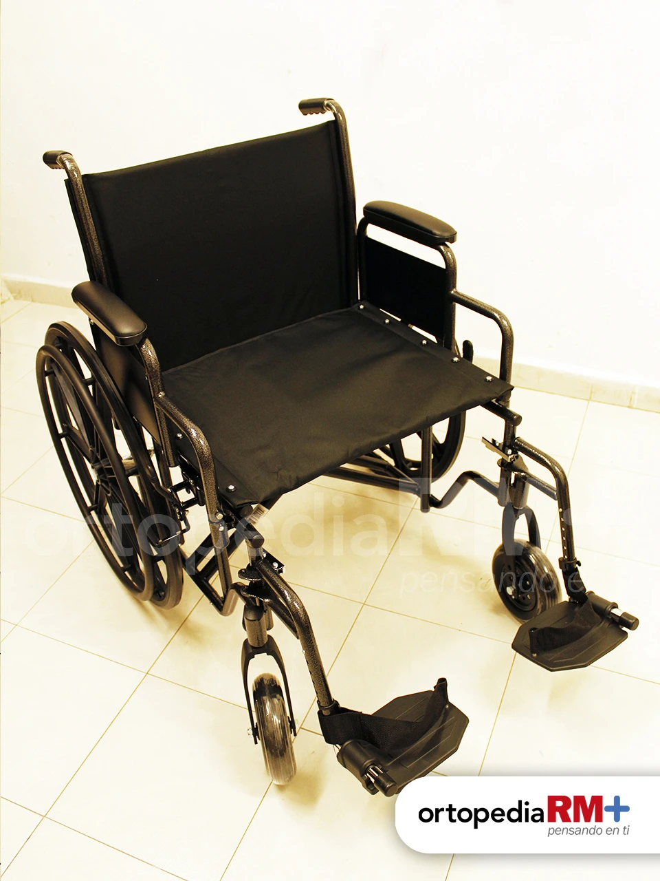 Silla de ruedas de traslado con ruedas pequeñas, estructura ligera y frenos de seguridad.